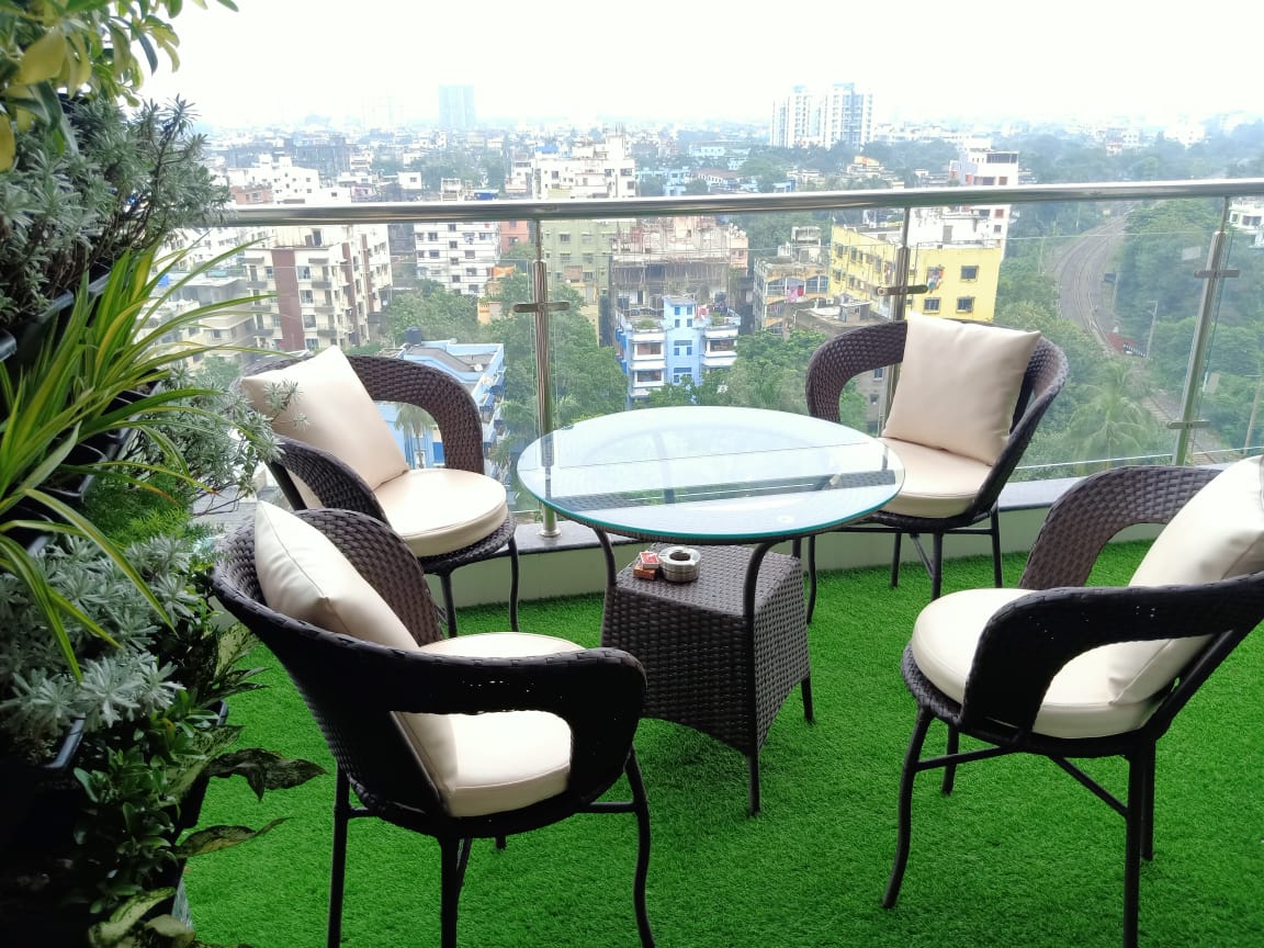 Rooftop balcony renovation with artificial turf and outdoor seating, Kolkata