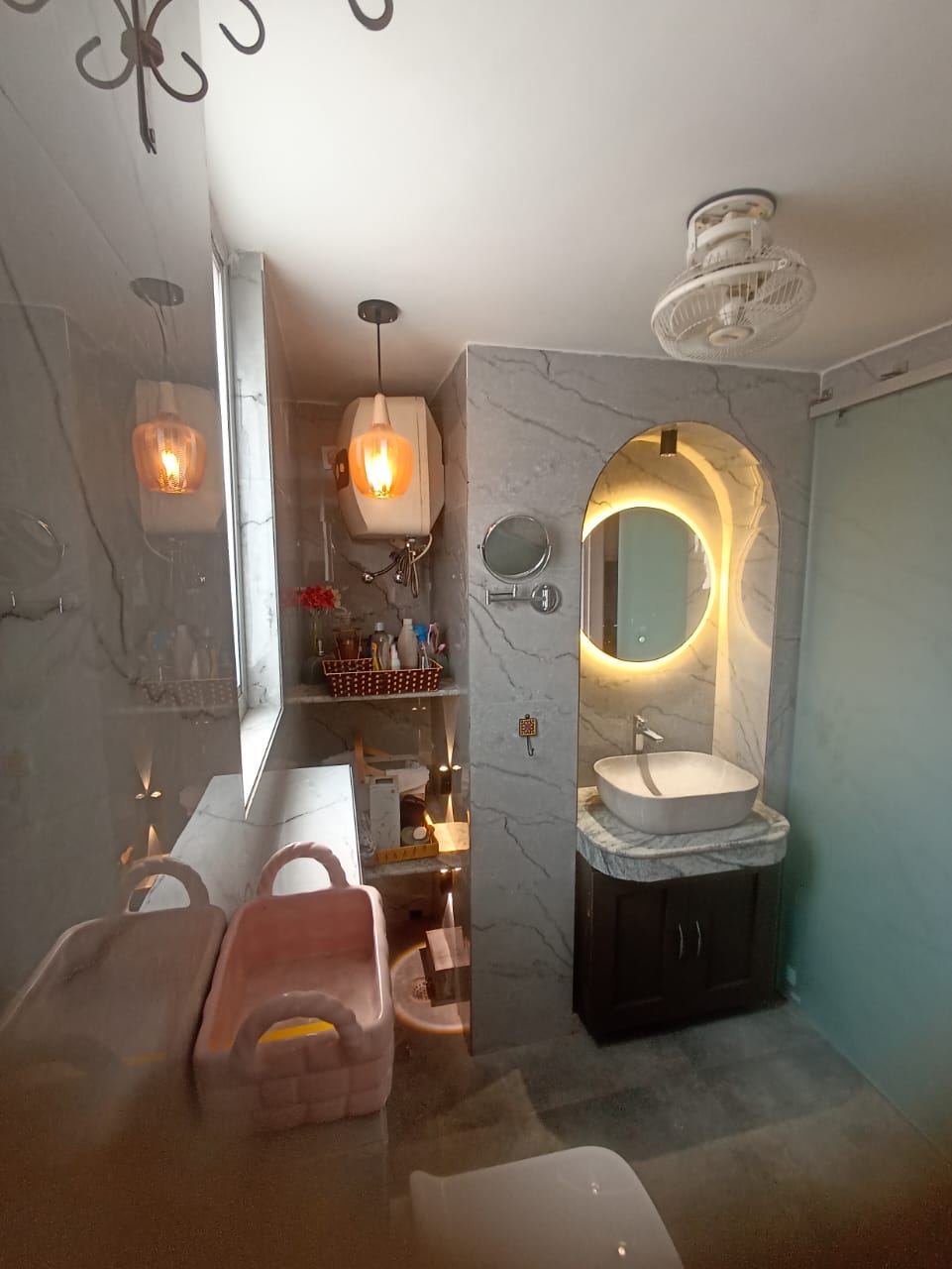 Bathroom interior with marble cladding and vessel sink