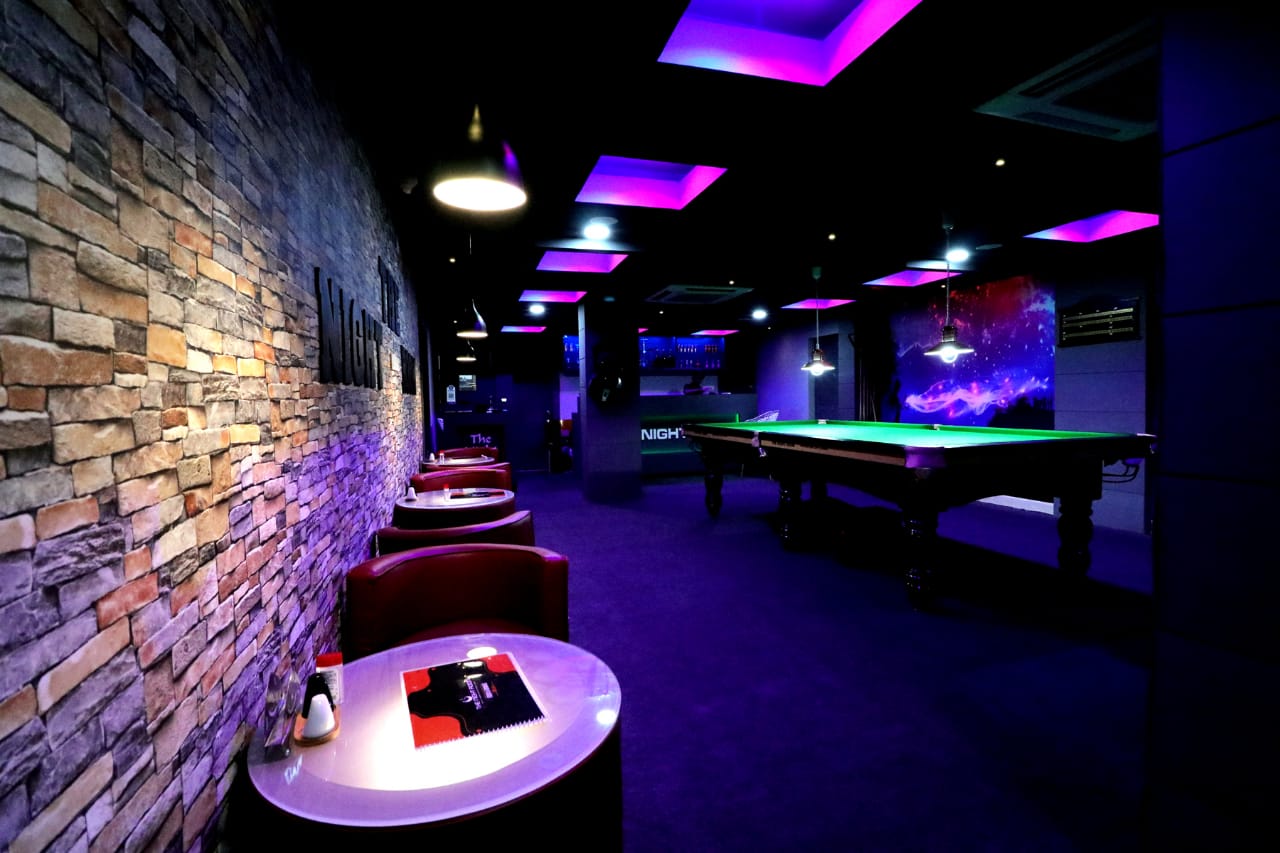 Commercial lounge interior with pool table and ambient lighting